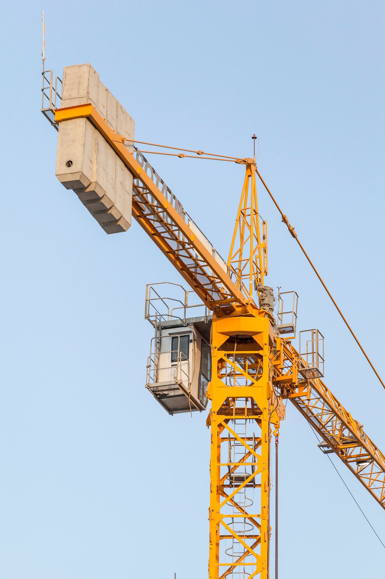 yellow construction crane against the blue sky infrastructure.jpg